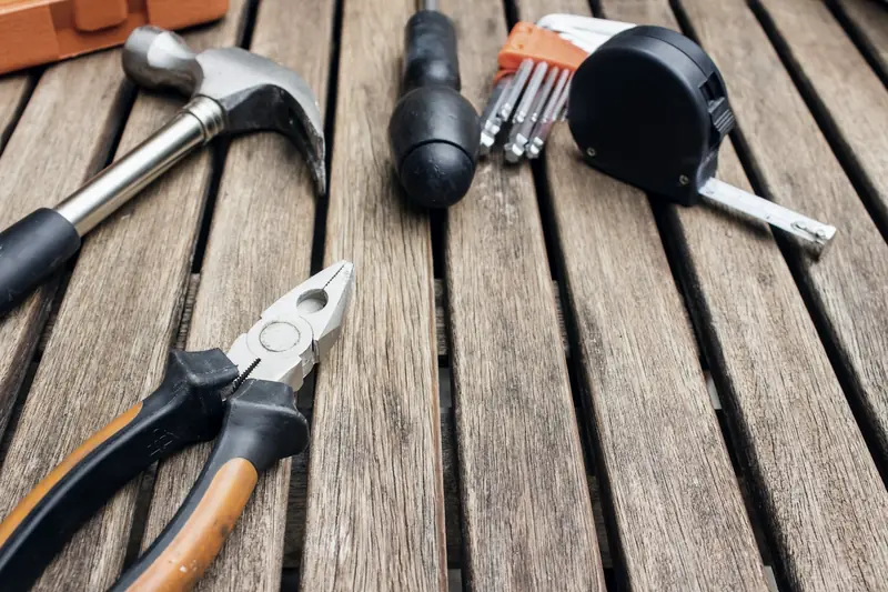 Carpentry hand tools laid out on a wooden surface